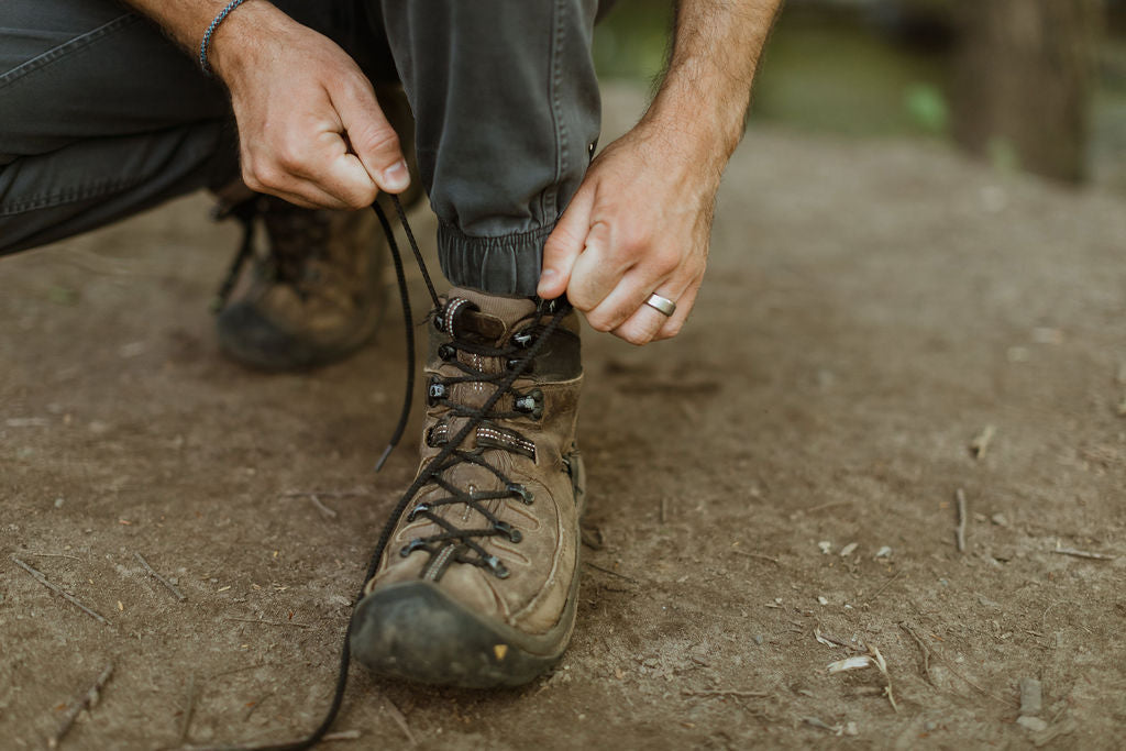 Man tying boot with Versa ring